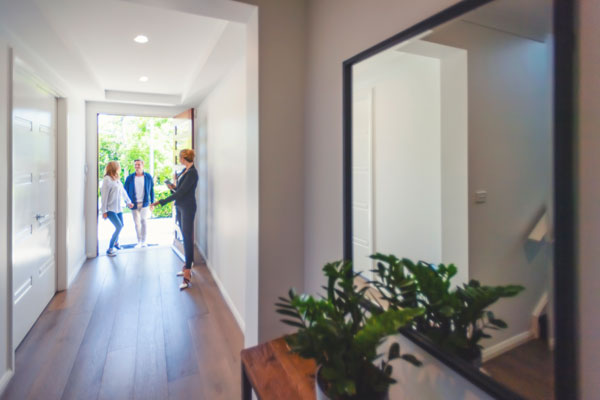 real estate agent showing a home to a couple